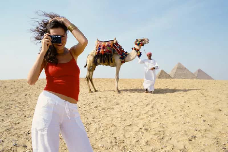 una turista scatta una foto alle piramidi , natale al cairo una turista scatta una foto alle piramidi , natale al cairo